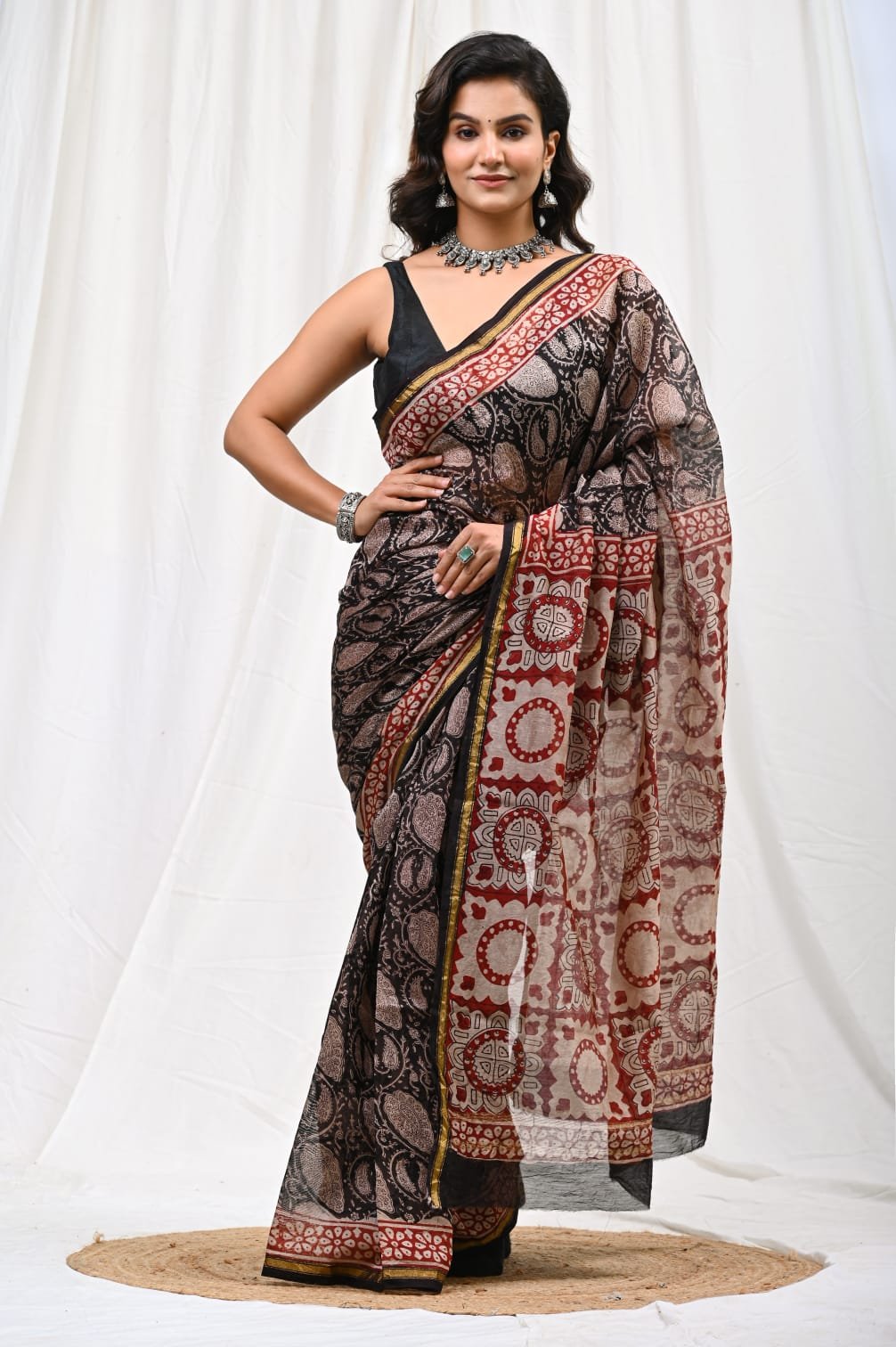 Black and red saree with floral motifs and geometric Bagru hand block prints