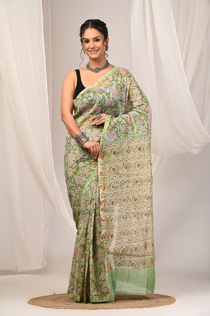 Saree in pastel green with floral motifs and geometric borders