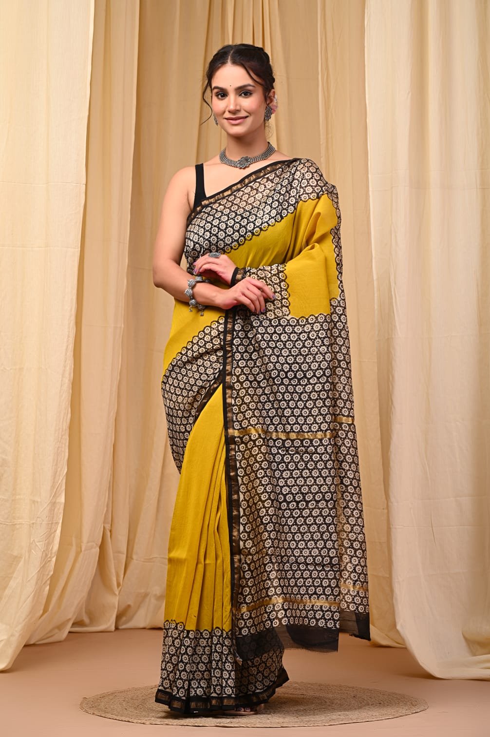 Yellow saree with black floral motifs and geometric patterns