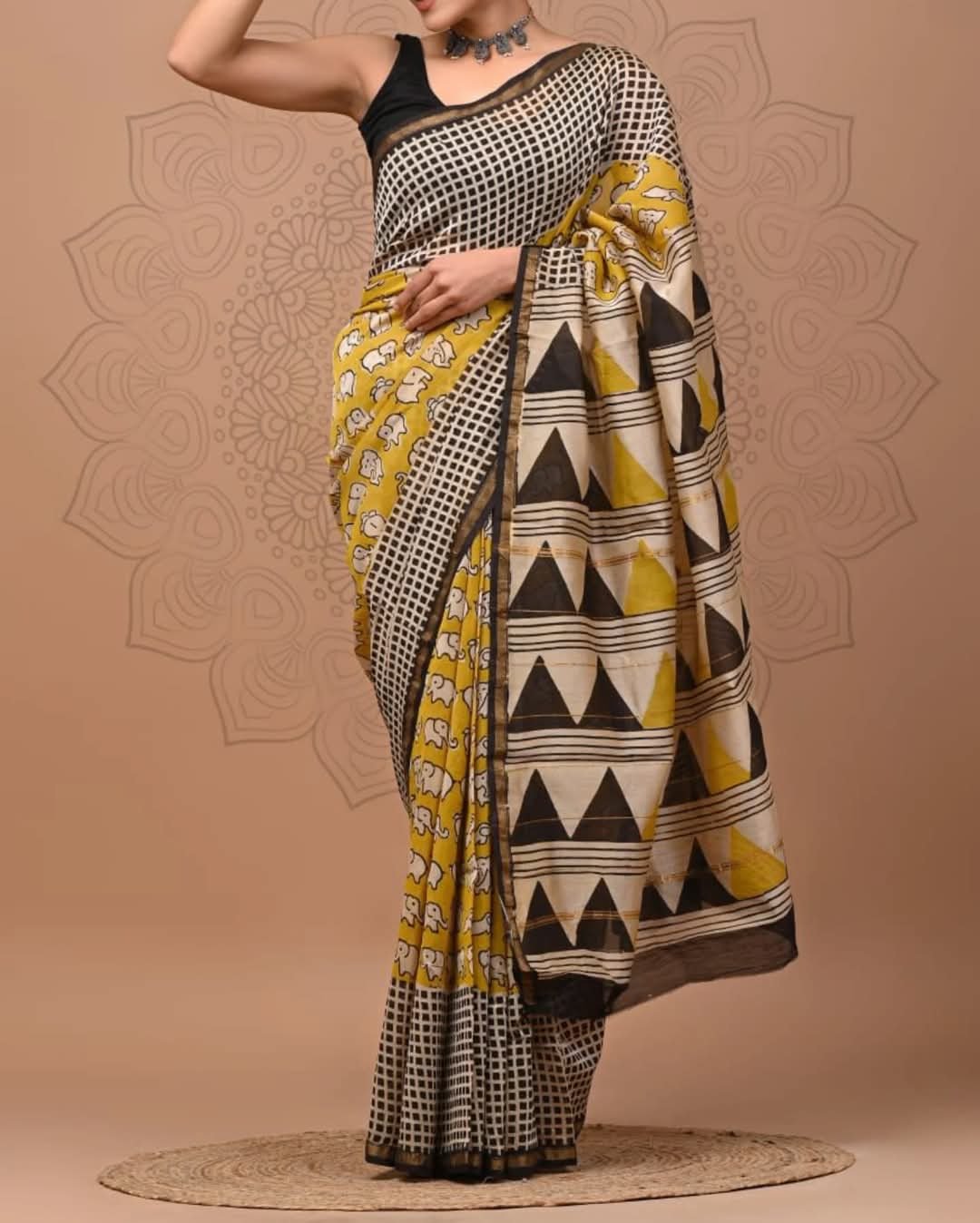 Yellow and black saree with elephant motifs and geometric patterns
