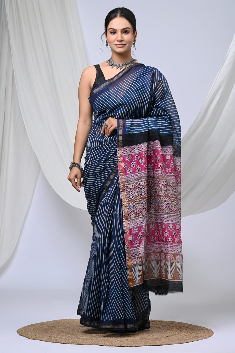 Blue striped Chanderi silk saree with pink floral motifs and intricate border