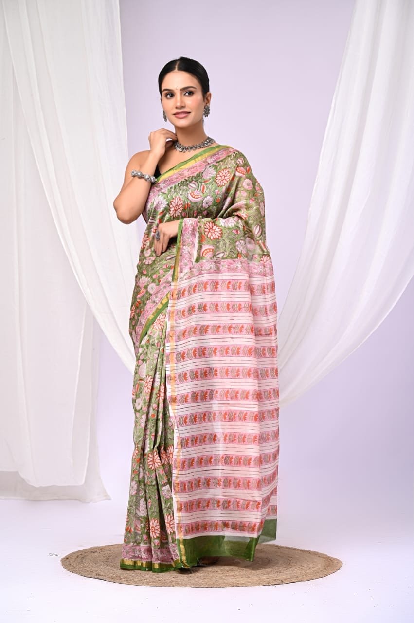 Green and pink saree with floral motifs and geometric border design