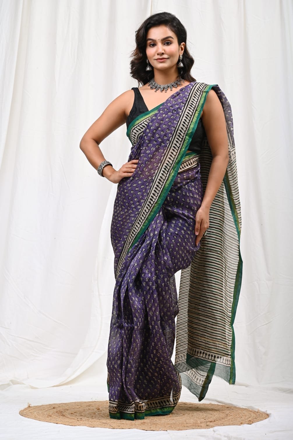 Purple saree with buti motifs, green geometric border and sheer Chanderi silk