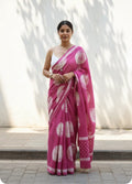 Pink saree with large white polka dots and intricate border design