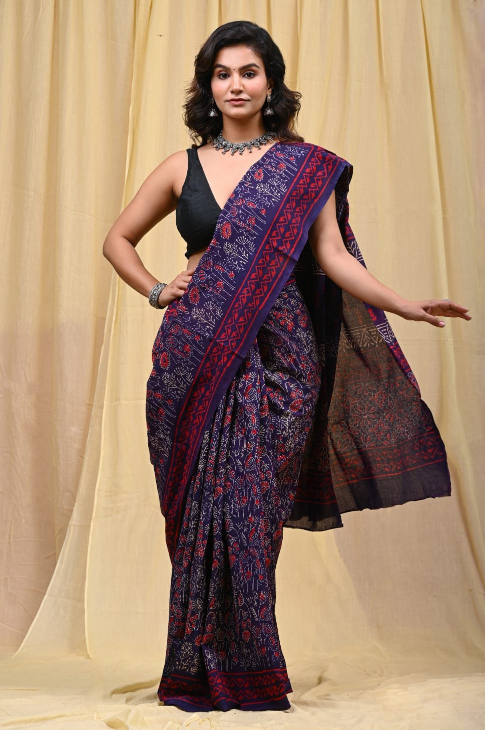 Navy blue saree with red floral motifs and traditional Bagru hand block print