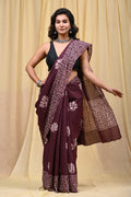 Maroon saree with lotus motifs and intricate border pattern