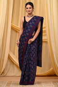 Navy blue saree with red buta motifs and intricate border