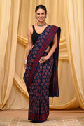 Navy blue saree with red floral and geometric patterns in Bagru print