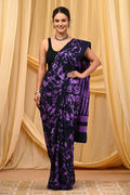 Purple and black saree with floral patterns and striped pallu design
