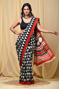 Black and white geometric patterned saree with red accents and striped pallu