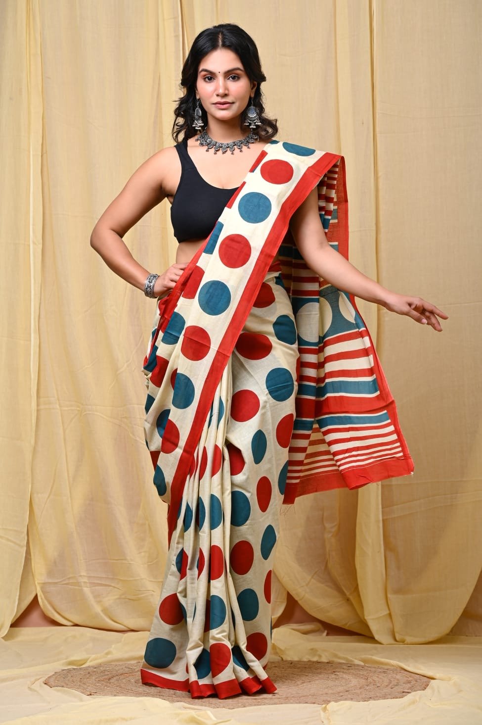 Red and blue polka dot design on ivory Mul Cotton saree with a striking border