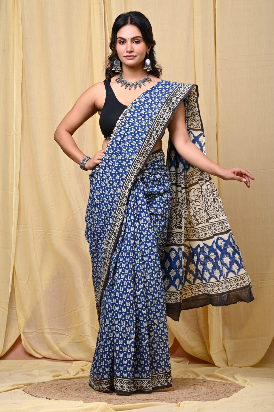 Blue saree with floral motifs and intricate border design