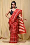 Red saree with white geometric block printed patterns and stripes.