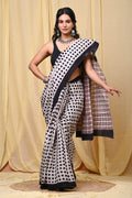 Saree with black and white polka dots, checked pallu, and black border