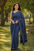 Indigo saree with white floral motifs and spiral border designs