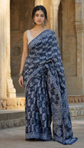 Navy blue saree with white floral motifs and geometric border
