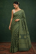 Green saree with floral motifs and intricate border design