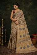 Beige saree with floral motifs in blue and brown using Bagru hand block print
