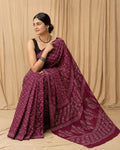 Maroon saree with floral motifs and swirl border in Bagru hand block print